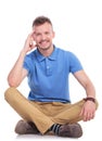 Seated young casual man smiles for you Royalty Free Stock Photo