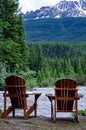 2 Seater Wood Adirondack Chairs buy a river in the canadain rockies Royalty Free Stock Photo