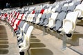 seating area detail of sport Stadium. curving rows of colorful plastic seats on steel frame.