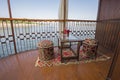 Seating on the balcony of a luxury river cruise boat with cocktails