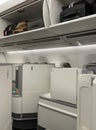 Seating and overhead lockers in Business Class on a modern jet.