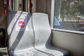 Seats in Belgrade tram, with warnings to keep distance due to Covid 19 pandemic