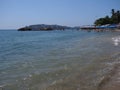 Seats, people and palm trees at sandy beach on bay of ACAPULCO city in Mexico with calm Pacific Ocean Royalty Free Stock Photo