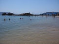 Seats and people at sandy beach on bay of ACAPULCO city in Mexico with calm Pacific Ocean Royalty Free Stock Photo