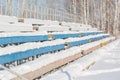 Seats in the stadium under the snow. Chairs for spectators at the stadium under the snow.