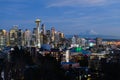 Seattle city skyline and Mount Rainier as the lights come on