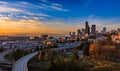 Seattle downtown skyline and skyscrapers beyond the I-5 I-90 freeway interchange at sunset in the fall with yellow foliage in the Royalty Free Stock Photo