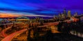 Seattle downtown skyline and skyscrapers beyond the I-5 I-90 freeway interchange after sunset at blue hour with long exposure