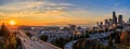 Seattle downtown skyline and skyscrapers beyond the I-5 I-90 freeway interchange at sunset in the fall with yellow foliage in the Royalty Free Stock Photo