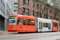 Orange Seattle streetcar to Hutchinson Center on wet street Royalty Free Stock Photo
