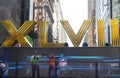 Seattle Seahawlks and Denver Broncos fans posing for picture next to Roman Numerals on Broadway during Super Bowl XLVIII week