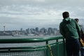 Passengers onboard the Bremerton-Seattle Washington State Ferry admire the Seattle Skyline