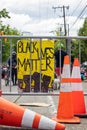 Seattle, WA - 11 June 2020. Black Lives Matter sign held at protest on streets and buildings