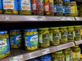 Seattle, WA USA - circa August 2022: Close up, selective focus on jarred pickles for sale inside a QFC grocery store