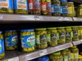 Seattle, WA USA - circa August 2022: Close up, selective focus on jarred pickles for sale inside a QFC grocery store