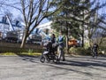 Seattle, WA USA - circa March 2022: View of a family pushing a baby stroller around the Seattle Center area downtown on a bright,