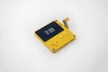 Seattle, WA USA - circa May 2022: Close up, selective focus on a yellow Playdate handheld gaming console against a white