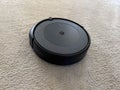 Seattle, WA USA - circa May 2023: Close up view of an iRobot Roomba on a light carpeted floor inside a family home Royalty Free Stock Photo