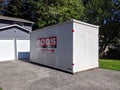 Street view of a PODS Moving and Storage cube sitting in a residential driveway Royalty Free Stock Photo