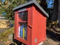 Seattle, WA USA - circa November 2022: Close up view of a red Little Free Library in a residential neighborhood