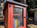 Seattle, WA USA - circa November 2022: Close up view of a red Little Free Library in a residential neighborhood