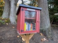 Seattle, WA USA - circa November 2022: Close up view of a red Little Free Library in a residential neighborhood