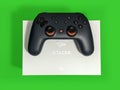Closeup of a Google Stadia gaming controller resting on top of a white box against a Royalty Free Stock Photo