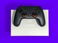 Closeup of a Google Stadia gaming controller resting on top of a white box against a Royalty Free Stock Photo