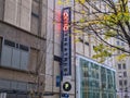 View of the outdoor neon sign for AMC movie theater in downtown Seattle on an overcast