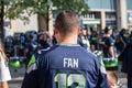 Seattle, Washington - 8/9/2018 : A fan in a 12th man fan watch the Blue Thunder drumline in front of CenturyLink Field