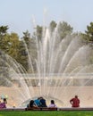 Seattle, Washington - 8/8/2018 : People outside enjoying a warm summer afternoon at the International Fountain in Seattle Center Royalty Free Stock Photo