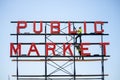 Seattle, Washington - 8/9/2018 : The Pike Place Public Market sign getting painted by workers Royalty Free Stock Photo