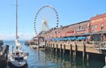 Seattle, Washington, 9/14/17, Seattle waterfront restaurant with a sailboat docked and The Great Wheel in the bachground Royalty Free Stock Photo