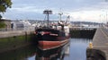 SEATTLE, WASHINGTON STATE, USA - OCTOBER 10, 2014: Hiram M. Chittenden Locks with large commercial fishing vessel docked Royalty Free Stock Photo