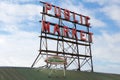 SEATTLE, WASHINGTON, USA - JAN 24th, 2017: Neon public market sign against cloudy sky, Pikes Place Market in downtown is