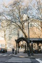 Seattle, Washington, USA. March 2020. Pergola-twisted iron and iron gazebo in pioneer square and homeless people on benches