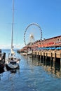 Seattle, Washington, 9/14/17, Seattle waterfront restaurant with a sailboat docked and The Great Wheel in the bachground