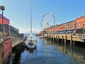 Seattle, Washington, 9/14/17, Seattle waterfront restaurant with a sailboat docked and The Great Wheel in the bachground Royalty Free Stock Photo