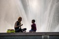 Seattle, Washington - 8/8/2018 : A woman and child outside enjoying a warm summer afternoon at the International Fountain