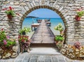 Seaview through the stone arch with flowers