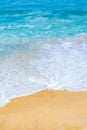 Seawater waves splash on sandy beach in summer day, wallpaper and background concept.