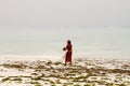 Seaweed farmers in the blue water off the white beach in Zanzibar