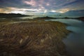 Seaweed on rock beach and sunset sky