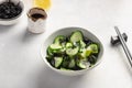 Seaweed wakame salad with cucumber in bowl on gray background. Royalty Free Stock Photo