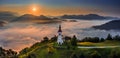 Sebrelje, Slovenia - Aerial panoramic drone view of the beautiful hilltop church of St.Ivan Sv. Ivan Cerkev at sunrise with fog Royalty Free Stock Photo