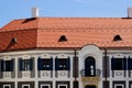 secessionist or art nouveau style renovated white stucco residential building. blue wood window shutters. stone balcony