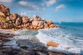 Secluded beach Grand L Anse in evening sunset light, La Digue, Seychelles. Tropical ocean coast, unique granite rocks