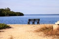 Secluded bench overlooking a large wetland marsh