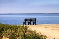 Secluded bench overlooking a large wetland marsh