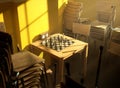 Secluded Chess Game Between Stacked Chairs